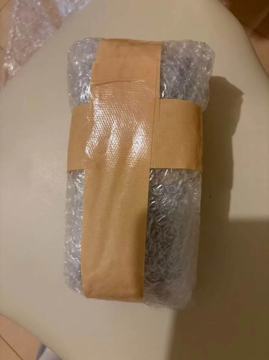 20 October 2026: protective wrapping before EMS shipment to the US.